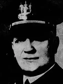 Black-and-white image of Stephen G. Nelson smiling wearing a police cap