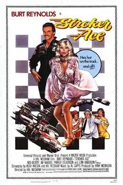 A smiling race car driver stands behind a glamorous blonde woman in a pink dress, with race cars speeding below them and a checkered flag background emphasizing the action.