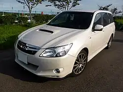 Subaru Exiga tS, a high-performance variant of the standard Subaru Exiga minivan. This photo shows the front of the car, which is white with a small "tS" emblem on the front grille, which stands for "tuned by Subaru".