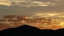 Sunrise over the summit of Mount Nardi from the south, showing the radio and digital television transmission towers