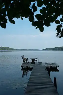 A typical Finnish pier with a table, chair and ladders for swimmers in Joutsa, Central Finland