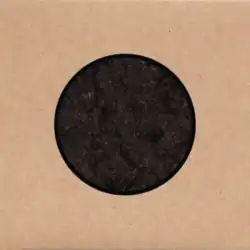 A circle filled with a dirt texture on a cardstock background