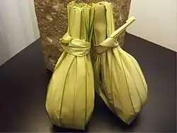 Leaf-wrapped rice dish (nasi kuning)