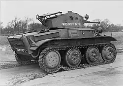 The side and rear of a Tetrarch light tank, with trees in the background