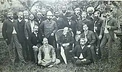A portrait of twenty men (five seated in front) on a lawn