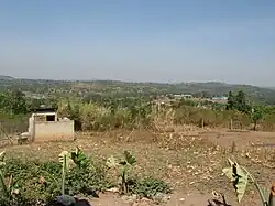 View from a hill near Kakiri, showcasing dry landed dominated by grassland, farms, and many small trees.
