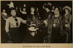 A photograph depicts the first woman jury in America casting their ballots into a hat