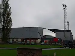 Photograph of Racecourse Ground. The view shows two of the stadium's stands, along with two floodlight pylons