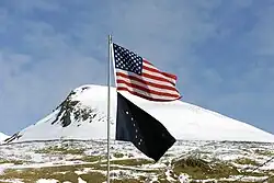 Flag of Alaska flying below the United States flag.