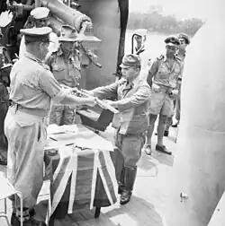 The official surrender ceremony of the Japanese to the Australian forces on board HMAS Kapunda at Kuching, Kingdom of Sarawak, on 11 September 1945