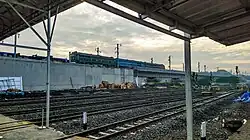 Two DF4B and one DF4C locomotives passing Padalarang Station, Indonesia