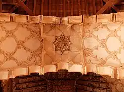 Sebka and other decorative motifs under one of the lambrequin arches next to the mihrab