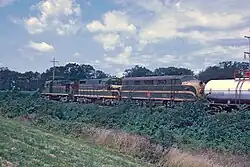 Three locomotives pulling a freight train