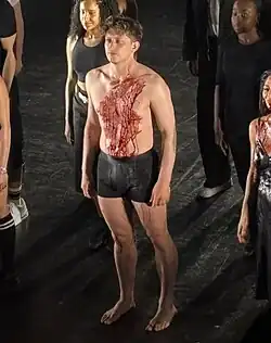 English actor Tom Francis during the bows of Jamie Lloyd's Sunset Boulevard; he is covered in fake blood