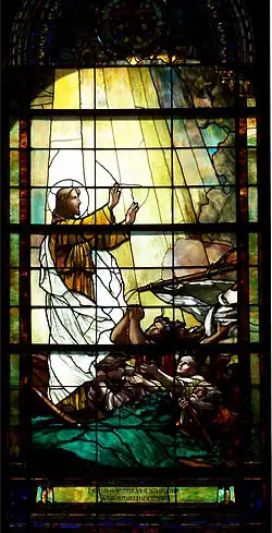 Christ and his disciples are in a small boat caught in a tempest. While the disciples beseech him, Christ raises his hand to calm the storm.