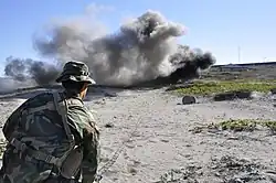 Third Phase A student detonates an explosive charge on San Clemente Island as part of his basic demolitions training.