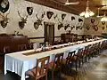 Dining room with hunting trophies lining the walls