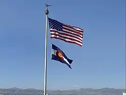 The national and state flags over the Colorado State Capitol
