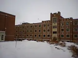 Exterior of a four-storey student residence building clad in red bricks and white trim