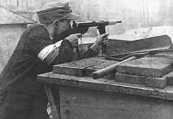 Member of the Polish Home Army defending a barricade in Warsaw's Powiśle district during the Warsaw Uprising, August 1944