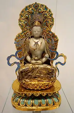 Statue of Vairocana, made in China during the Qing dynasty. 19th century. Made of jade, gilt bronze, enamel, pearls and kingfisher feathers. Displayed at the Royal Ontario Museum.