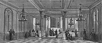 Black-and-white photo of an empty room with desks