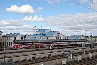 A large railway station with two trains