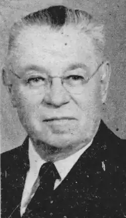 1958 black and white head and shoulders newspaper photo of Walter H. Cleary in suit and tie, turned slightly right, looking straight