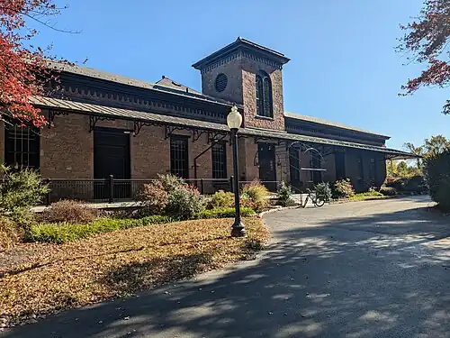 Single-story brick building with tower in the center