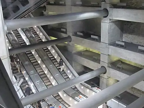 Image 34Escalators at Westminster Underground station descend between beams and columns of the station box to reach the deep-level Jubilee line platforms.