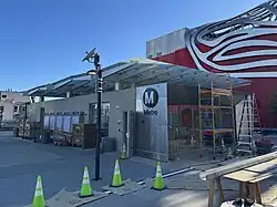 Headhouse of the Wilshire/Fairfax Metro station, still under construction, with the Petersen Automotive Museum in the background.