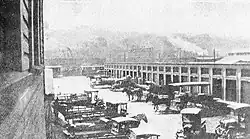 Early trucks at a large freight terminal building