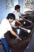 Workers performing fixation (kill-green) on tea leaves at a Chinese plantation, 1987
