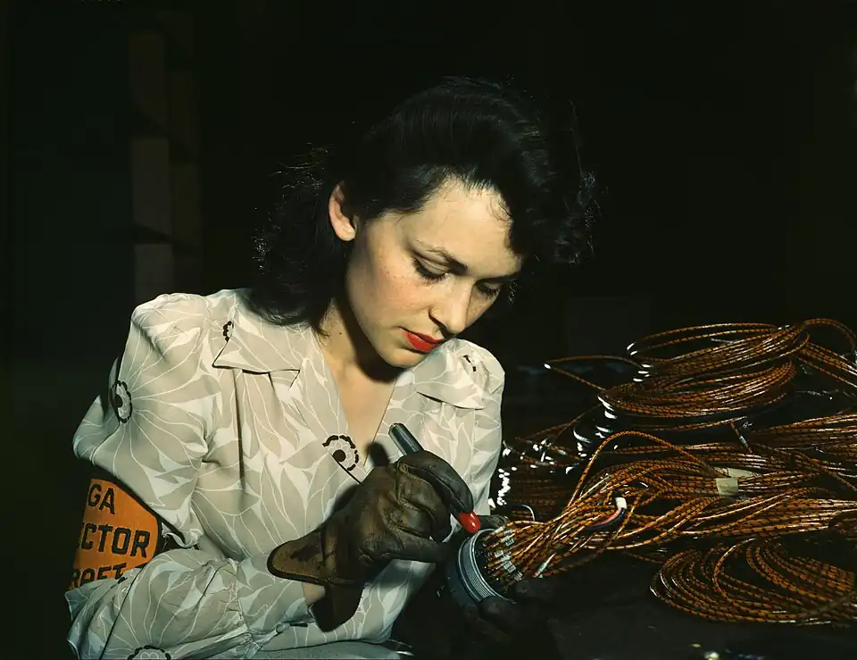 Image 18During World War II, a female aircraft worker checks electrical assemblies at the Vega Aircraft Corporation in Burbank, California.