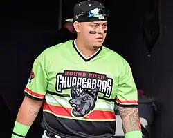 Pozo in a green Round Rock Express shirt in 2022.