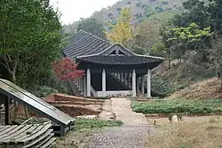 A traditional kiln surrounded by trees