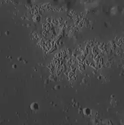 Hollows in Zeami crater. Image width is about 23.2 km.