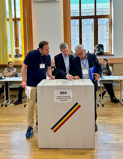 OSCE observers verifying ballot box seal at a Bucharest polling station