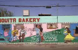 San Anto Cultural Arts' mural "Familia y Cultura es Vida" on an exterior wall of the Chiquita Bakery in the Mission District of San Antonio, Texas